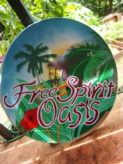 Hand painted sign with tropical island scene.